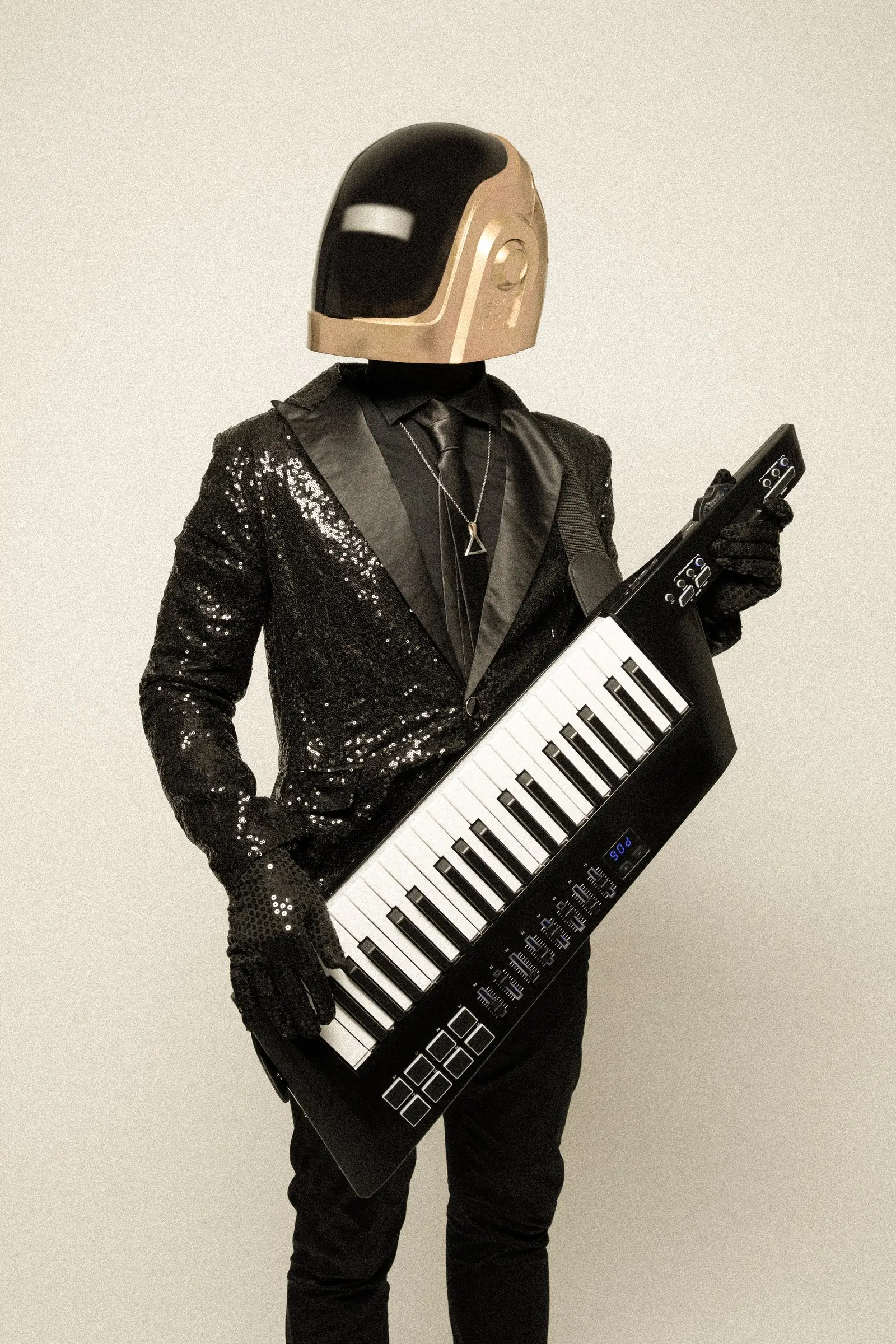 The gold-helmet performer playing a keytar